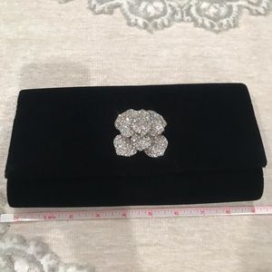 Black velvet evening back with rhinestone flower